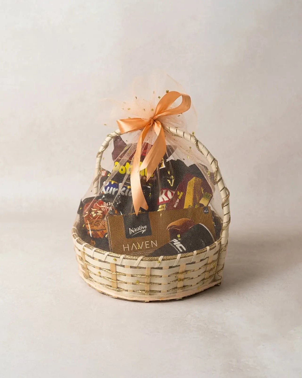 Dark chocolate and snacks gift basket with Haven chocolate, Kurkure and Doritos in round woven basket by The Love Language Pakistan