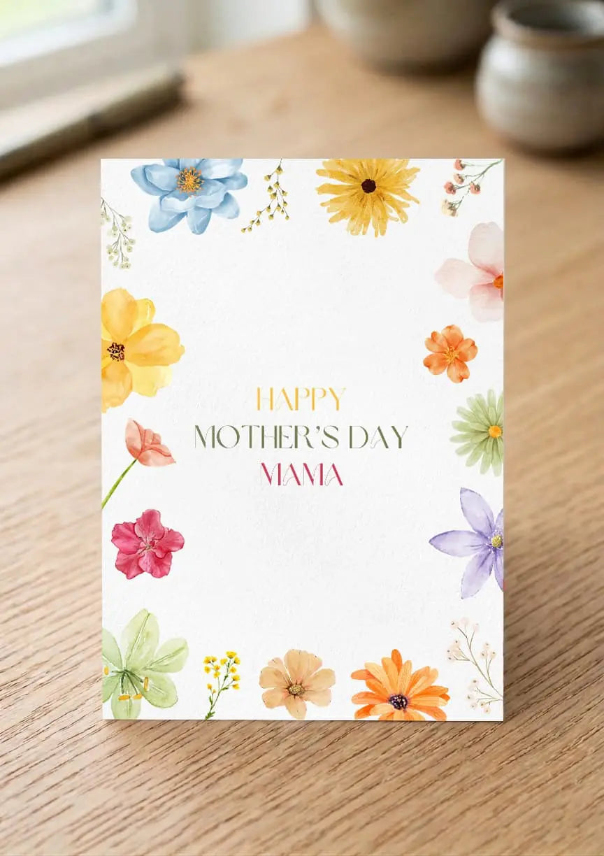Greeting card with colorful flowers and 'Happy Mother's Day, Mama' text on a wooden surface.