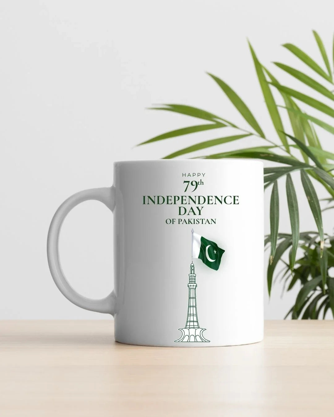 Minimal white mug with Minar-e-Pakistan, flag on flagpole, '79th Independence Day' typography — 14 August Pakistan Independence