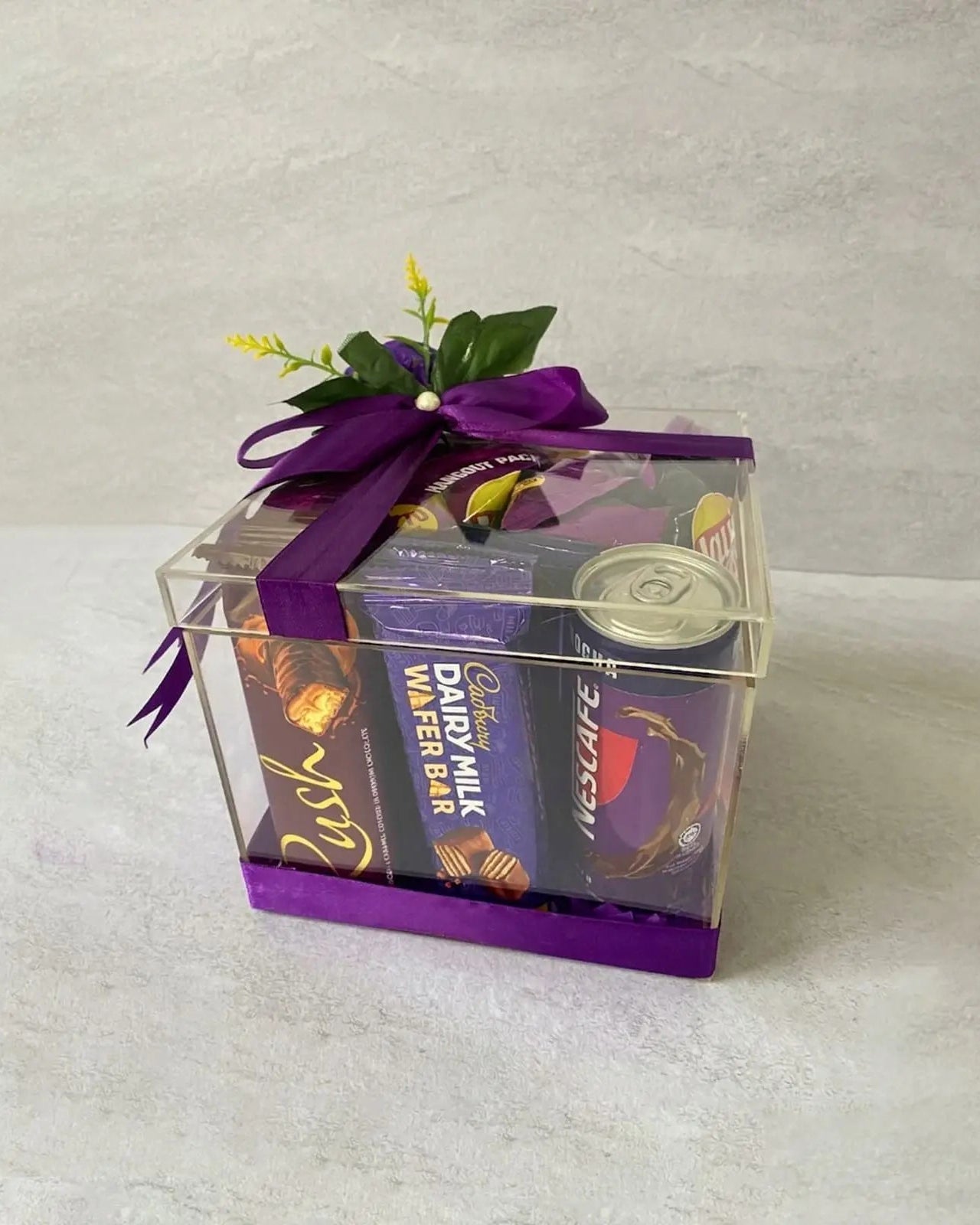 Purple chocolate hangout gift box with Dairy Milk Wafer Bar and Rush chocolate in clear acrylic box by The Love Language Pakistan