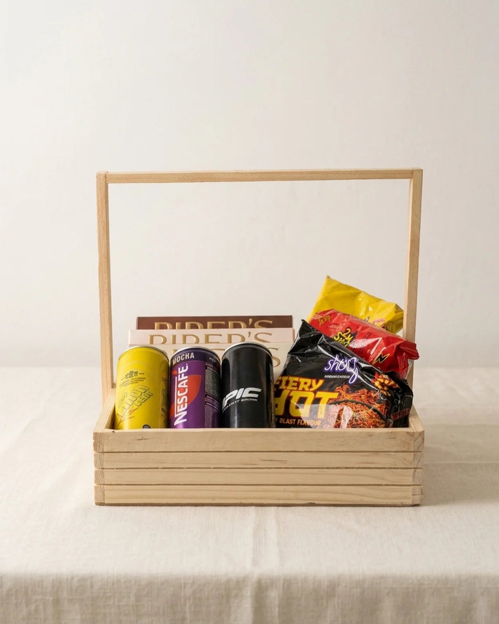 Wooden 12x12 spicy hangout snack tray with Samyang Buldak noodles, Nescafe Mocha, Epic drink and Piper's Gold cookies gift hamper by The Love Language Pakistan