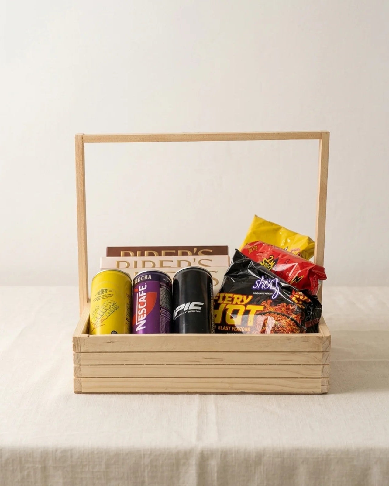 Wooden 12x12 spicy hangout snack tray with Samyang Buldak noodles, Nescafe Mocha, Epic drink and Piper's Gold cookies gift hamper by The Love Language Pakistan