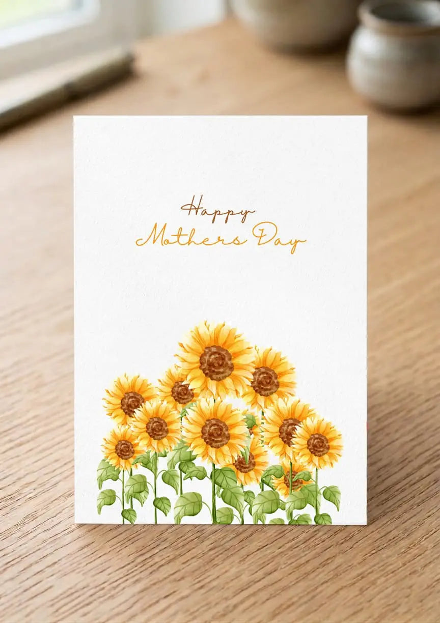 Greeting card with sunflowers and 'Happy Mother's Day' text on a wooden surface