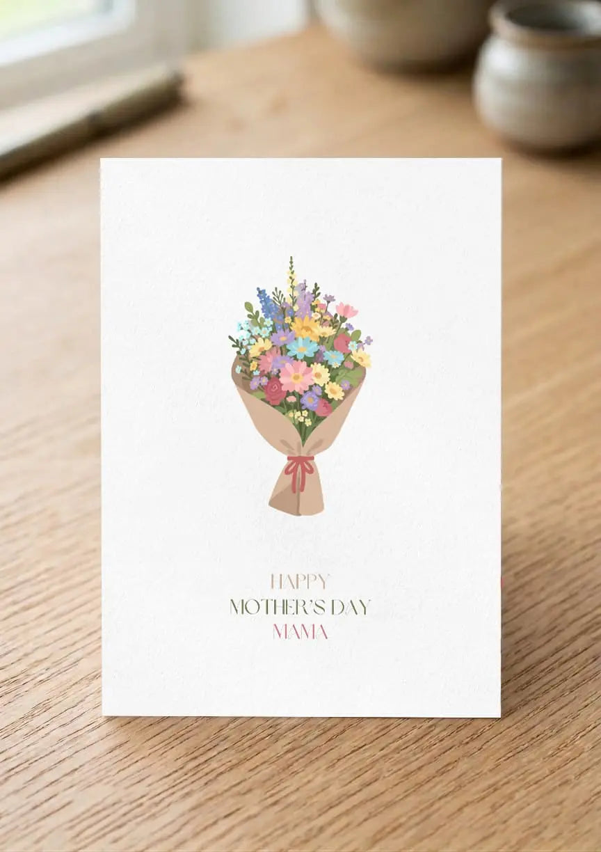 Greeting card with floral design and 'Happy Mother's Day, Mamma' text on a wooden surface.