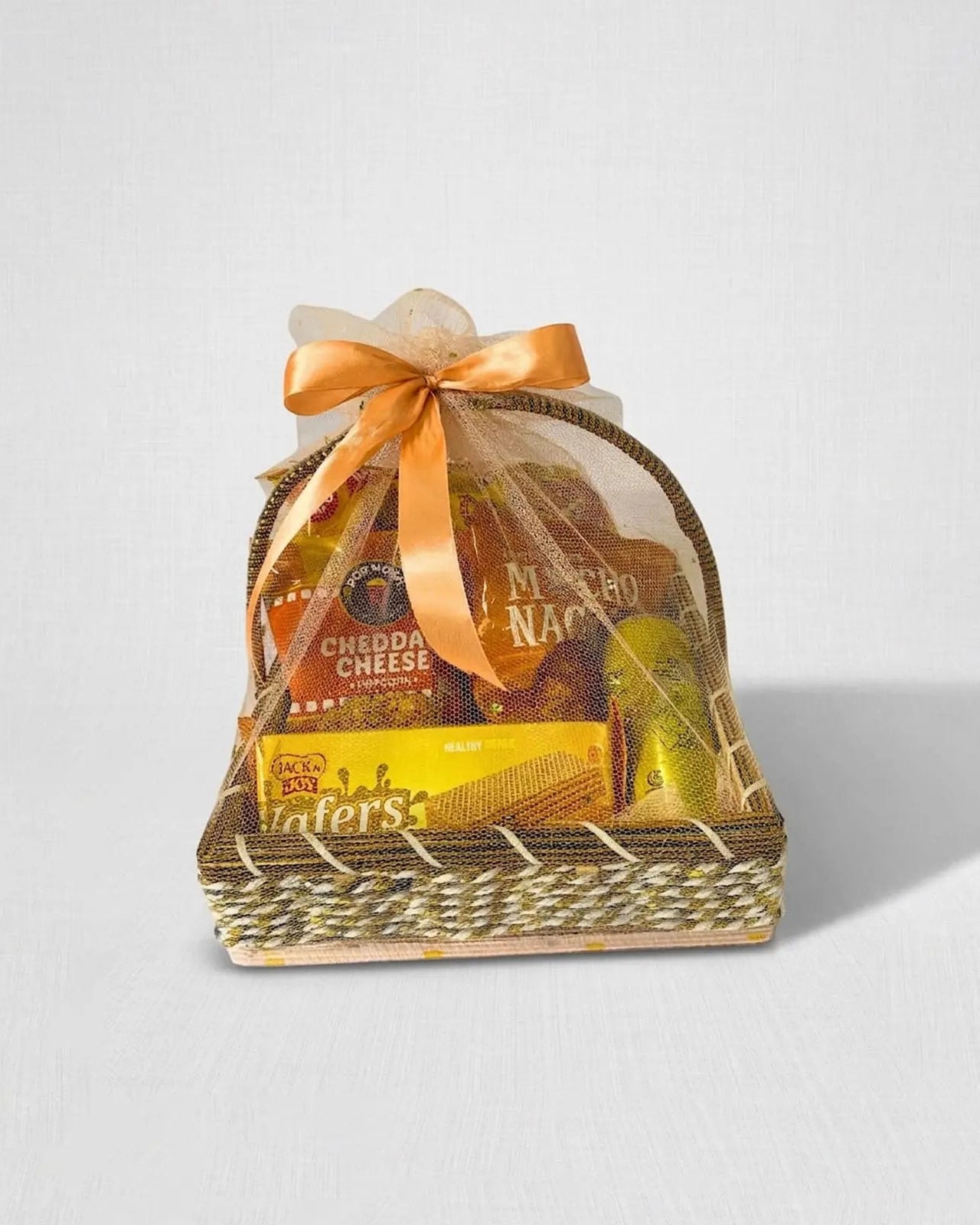 Yellow cheddar cheese popcorn and nachos snack gift basket with organza wrap by The Love Language Pakistan